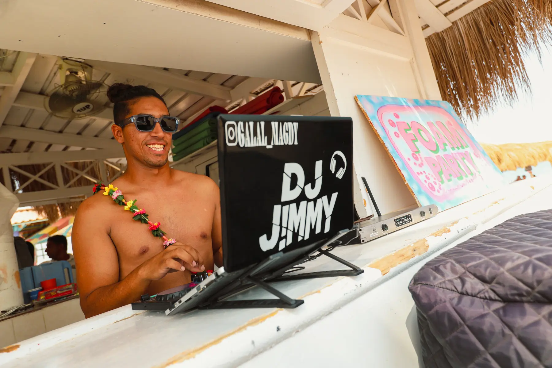 Beach DJ entertaining guests during daytime activities at Caribbean World Resorts Hurghada on the Red Sea