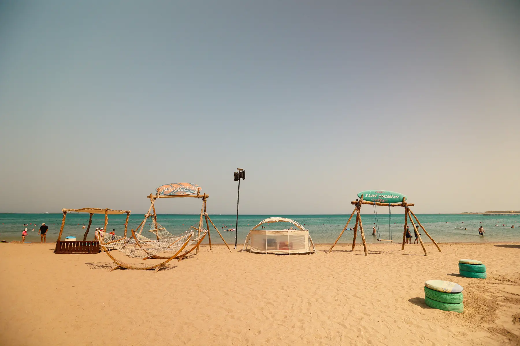 Central beach hammock area with sunbeds and umbrellas at Caribbean World Resorts Hurghada on the Red