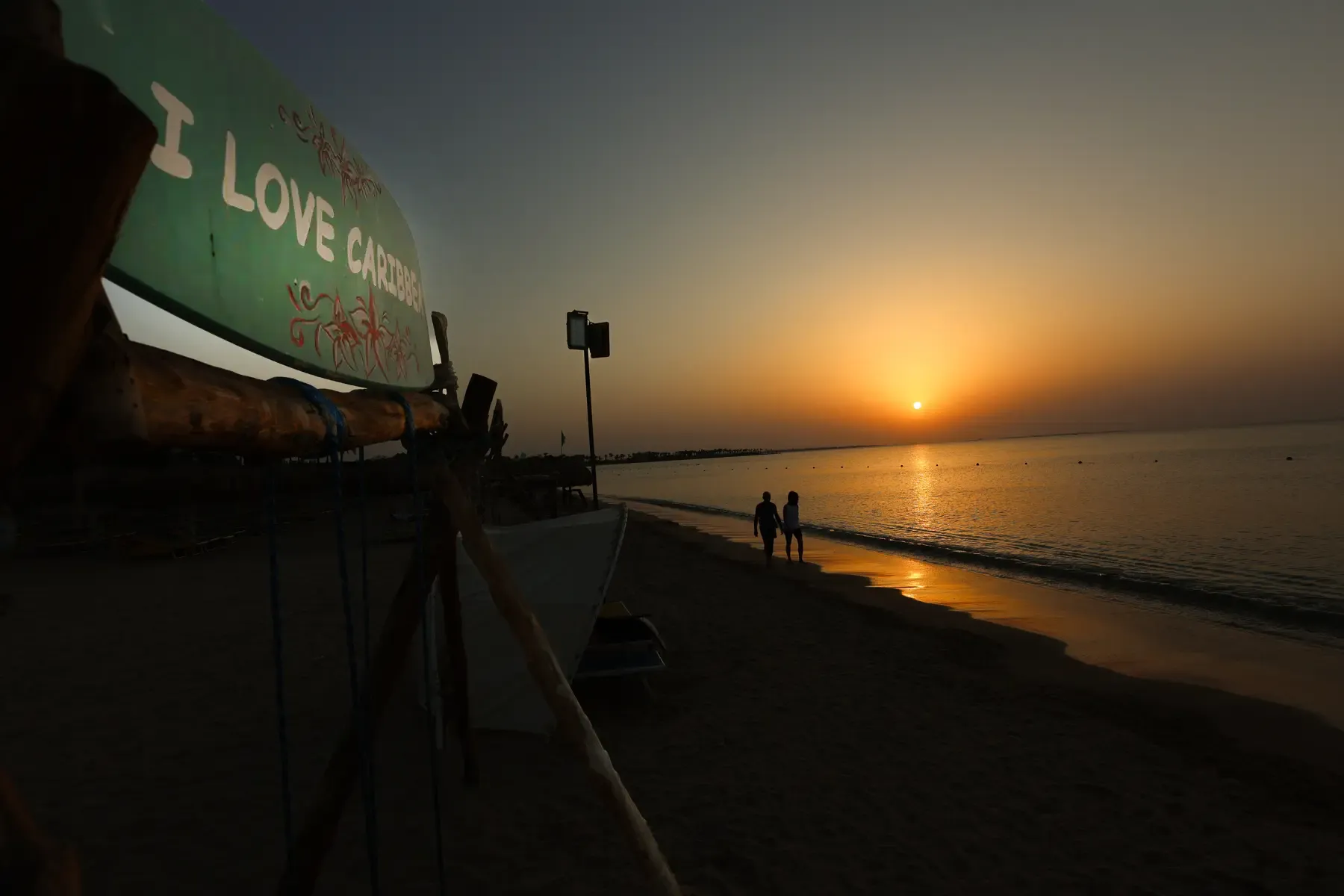 Caribbean World Resort Hurghada beach at sunrise with calm sea and soft morning light