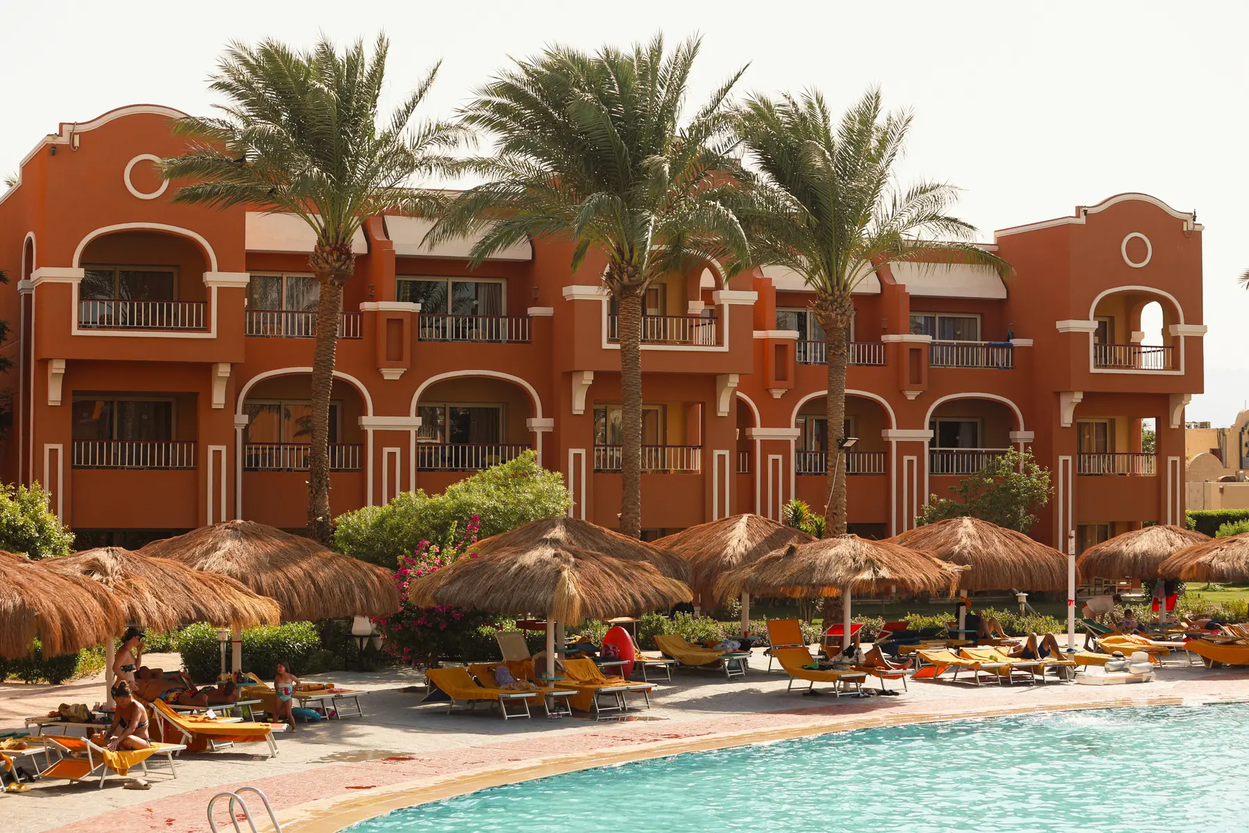 Poolside building view at Caribbean World Resorts Hurghada beside the resort swimming pool photographed by VirtuPeek