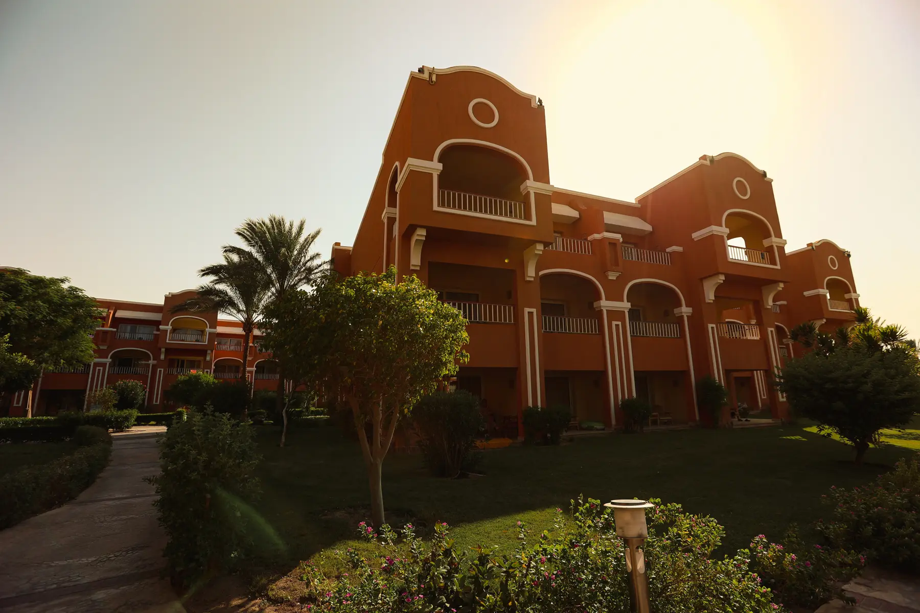 Resort building surrounded by landscaped gardens at Caribbean World Resorts Hurghada