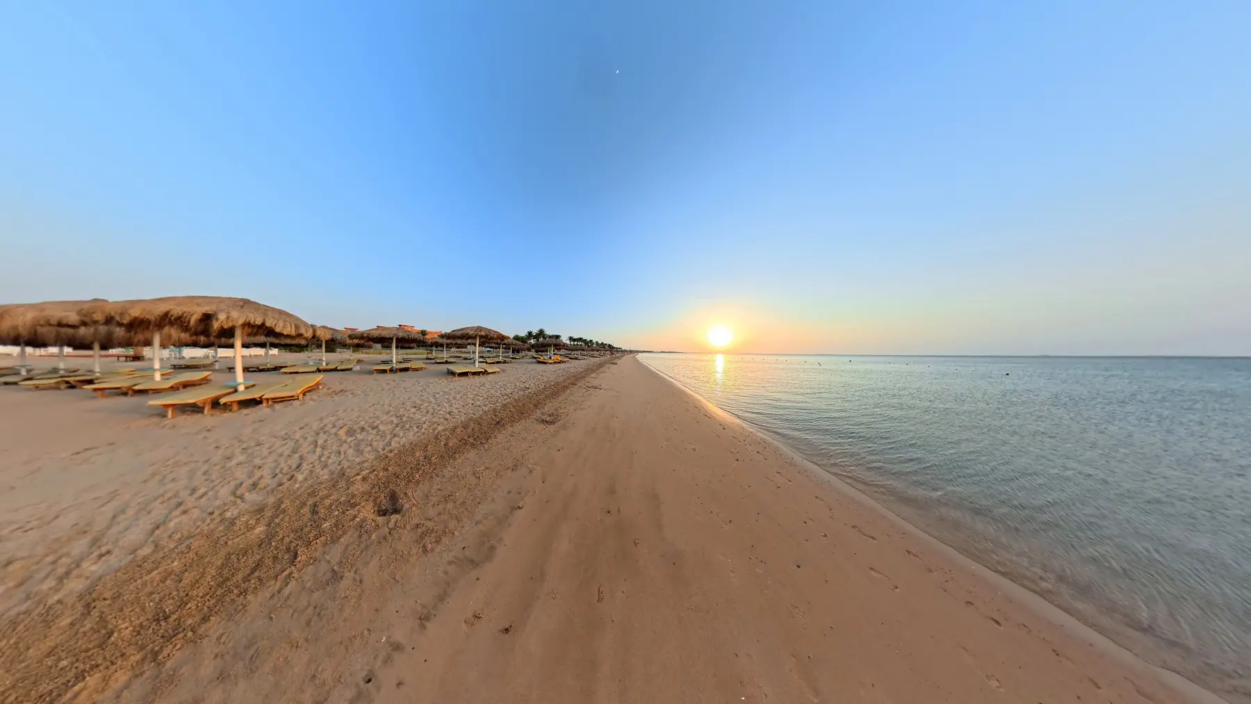 Sunrise light over the Red Sea beach at Caribbean World Resorts Hurghada photographed by VirtuPeek in a wide horizontal scene