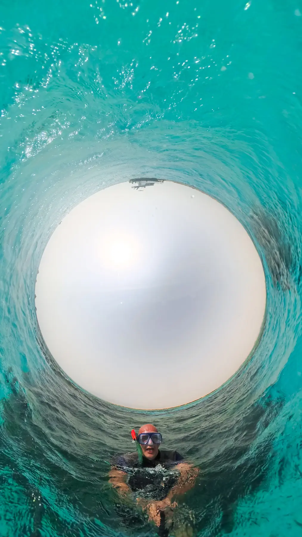 Underwater swimmer in Caribbean World Resorts Hurghada pool captured in 360 tiny planet perspective